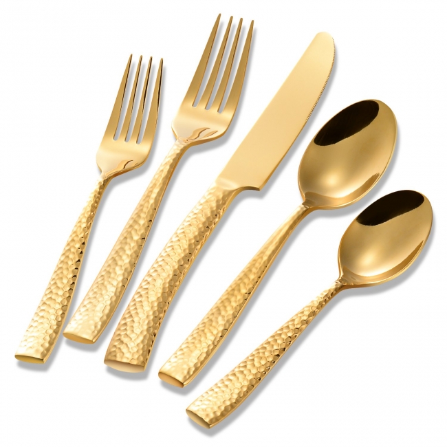Luxurious gold flatware on white background