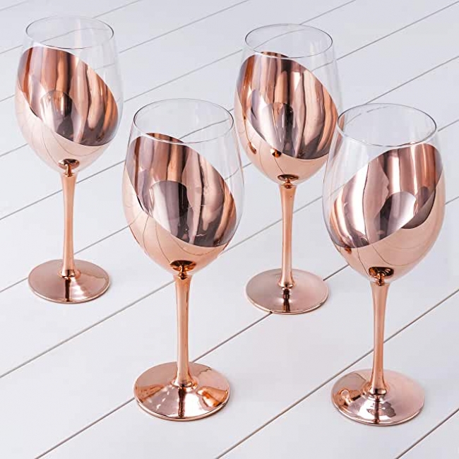 Four copper wine glasses on display.