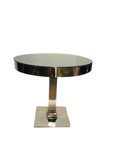 Sleek circular table with reflective surface.