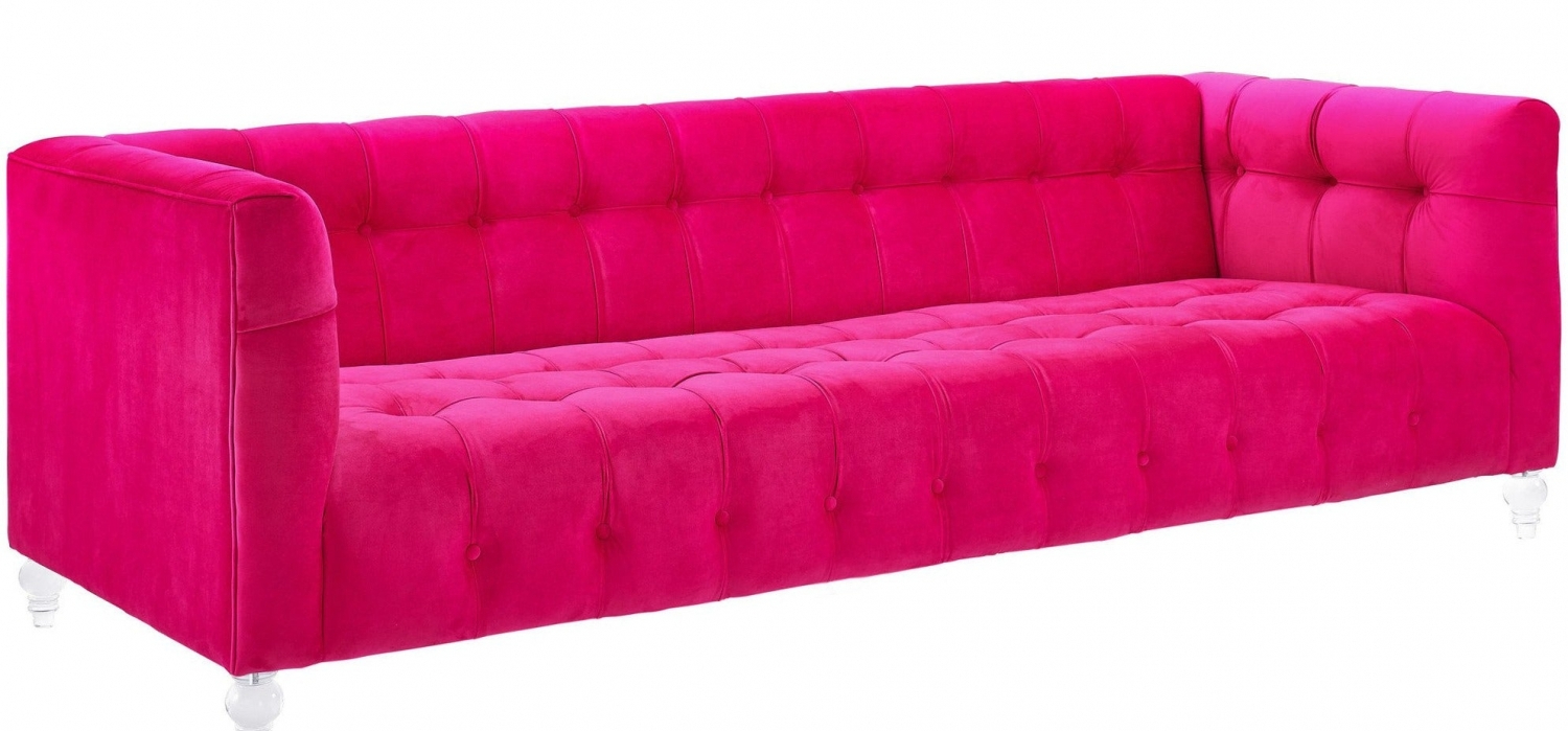 A bright pink, tufted velvet sofa with square arms and clear legs, shown against a white background.