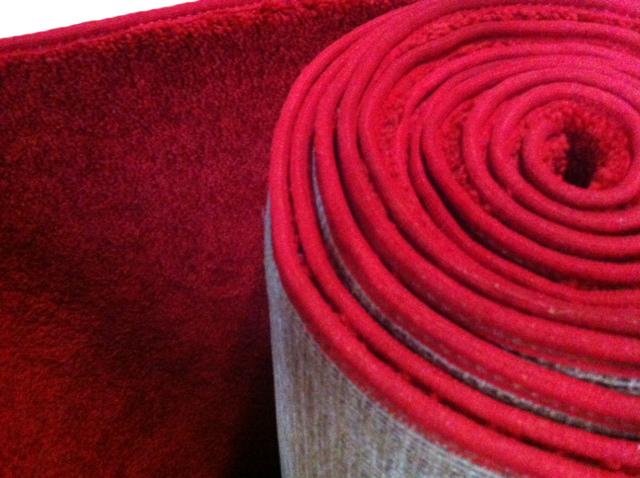 Rolled red carpet close-up