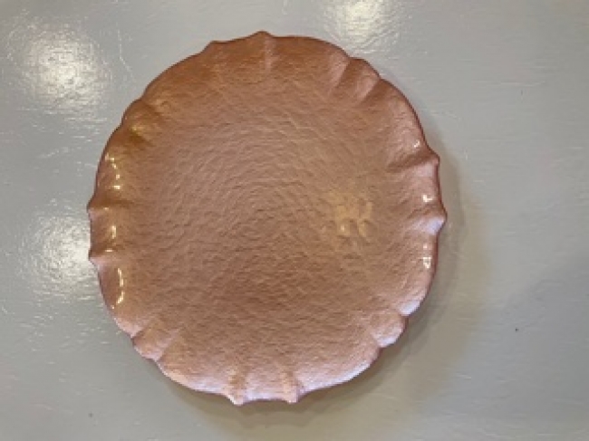 Round copper plate on display