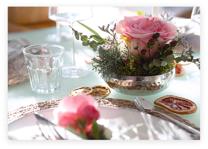 Elegant table setting with pink rose centerpiece