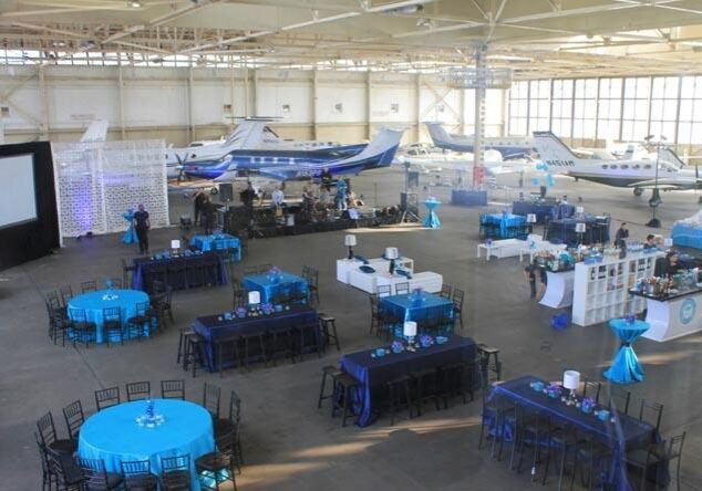 Airplane hangar event setup with tables