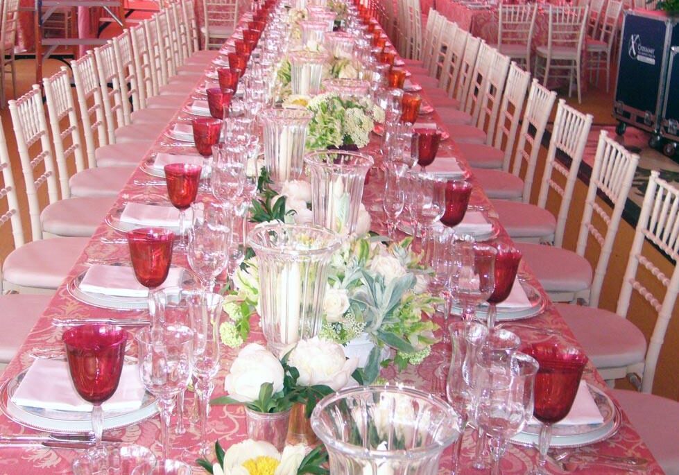 Long dining table with red glasses