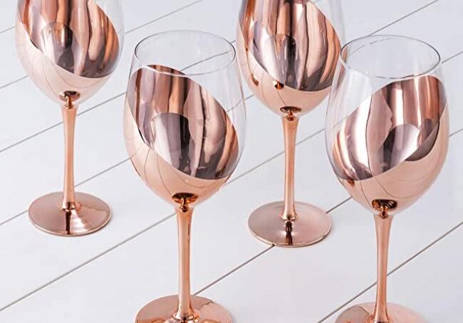 Four copper wine glasses on display.