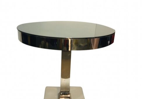 Sleek circular table with reflective surface.