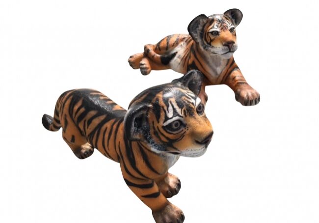 Small tiger models in playful poses