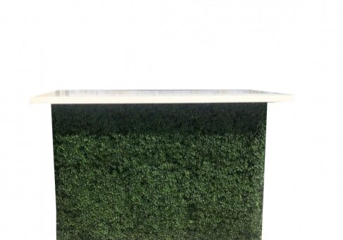 Modern table with grass-covered front