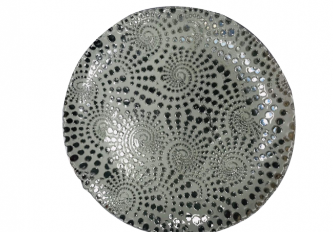 Textured ceramic plate with black dots
