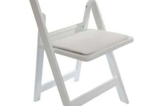 White folding chair with cushioned seat.