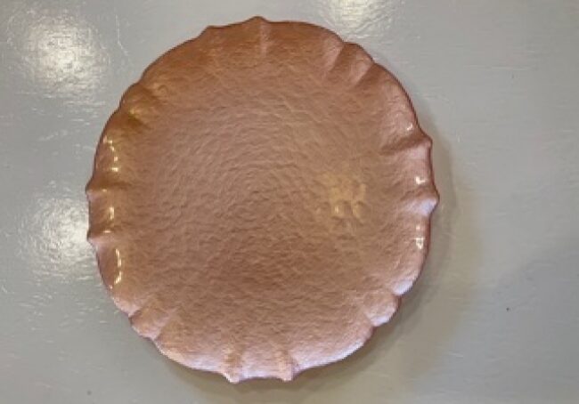 Round copper plate on display
