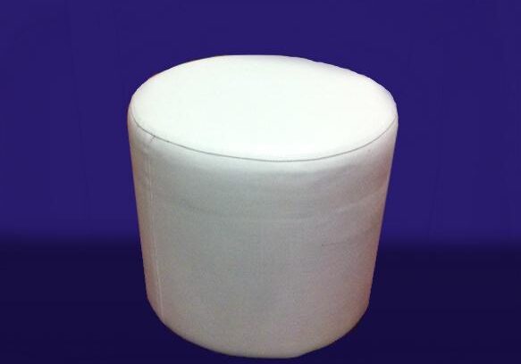 Cylindrical white stool on dark backdrop